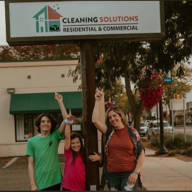Team pointing to sign